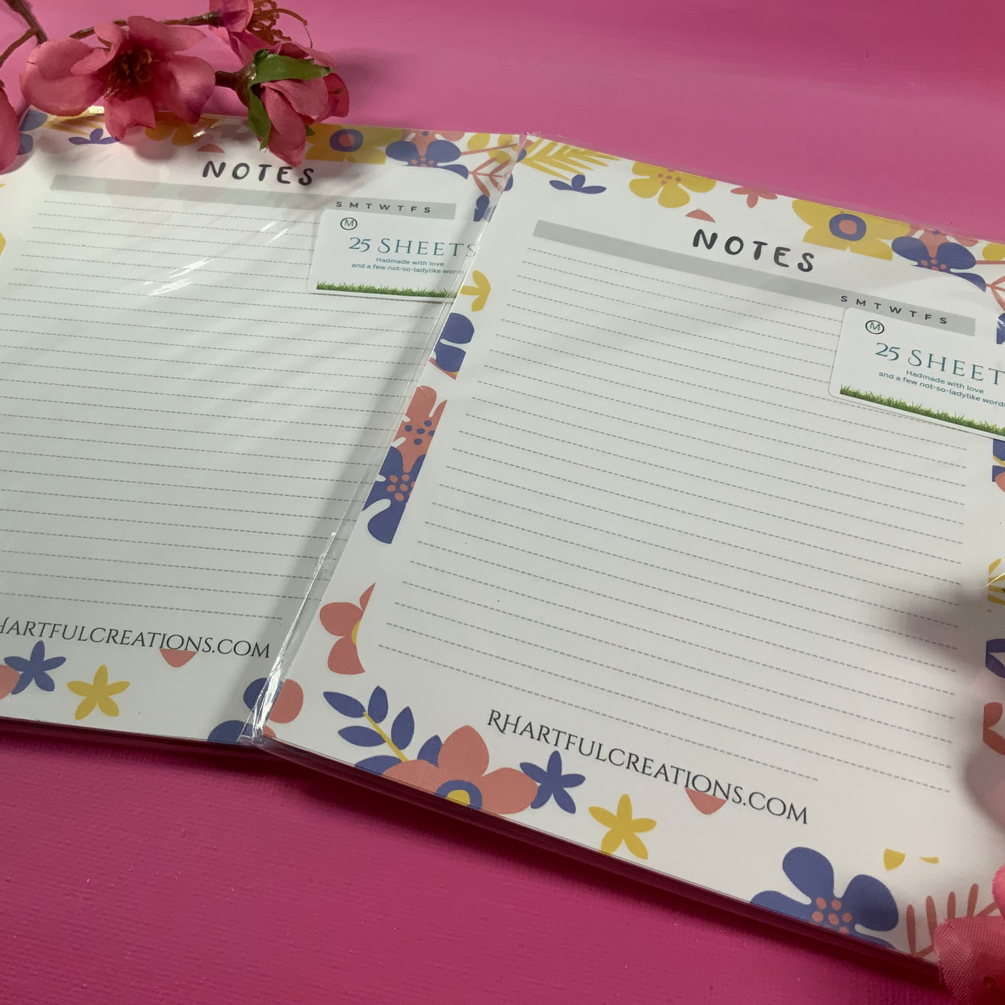 Floral notebook with lined pages on a pink background