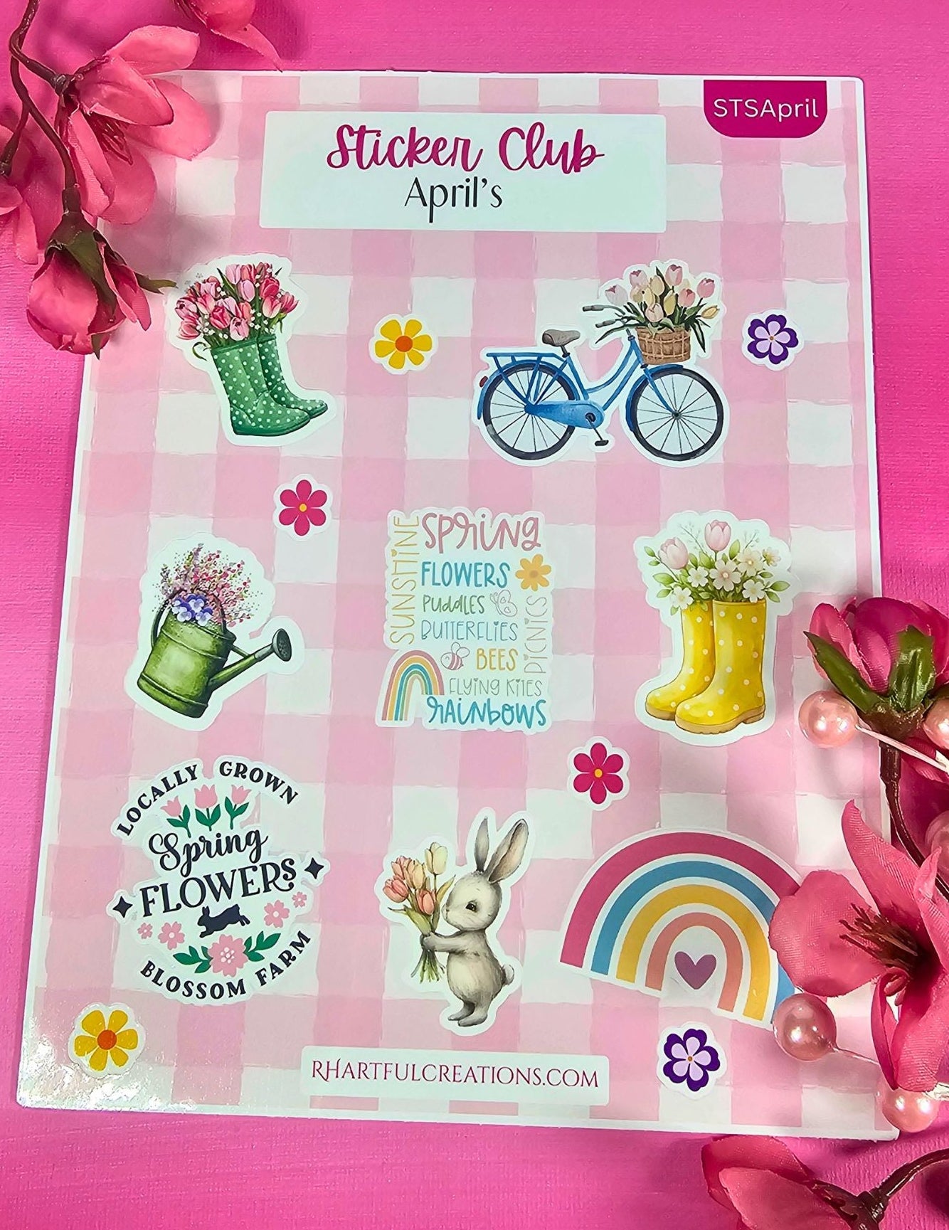 Sheet of spring-themed stickers with flowers, rainbows, and bunnies on a pink background with 'Sticker Club' branding.