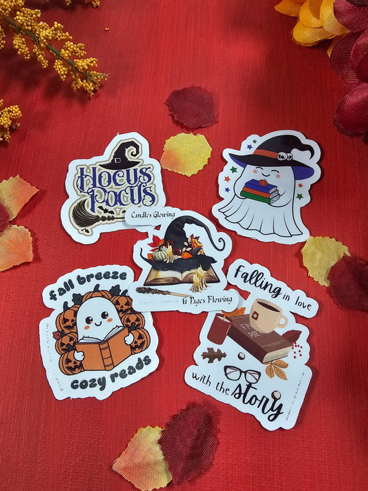 Set of Halloween-themed stickers on a red surface with autumn leaves.