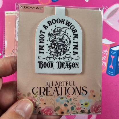 Bookworm-themed product with decorative text and design on a pink background