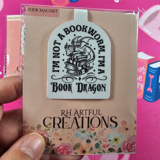 Bookworm-themed product with decorative text and design on a pink background