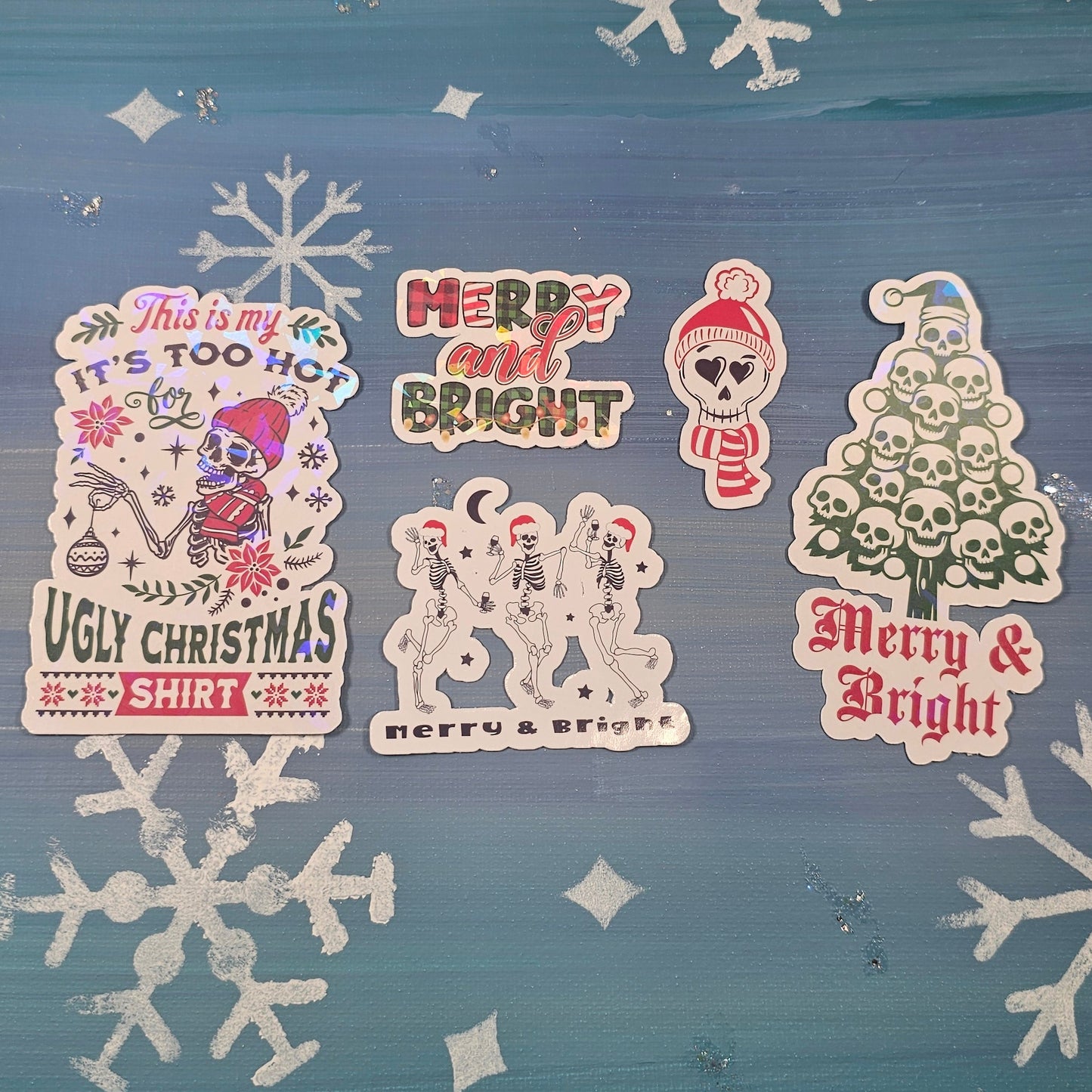 Decorative window with Christmas-themed stickers and snowflakes on a blue curtain.