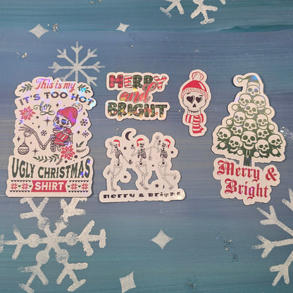 Decorative window with Christmas-themed stickers and snowflakes on a blue curtain.