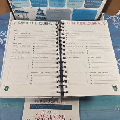 Open gratitude journal on a colorful surface with visible text and branding.