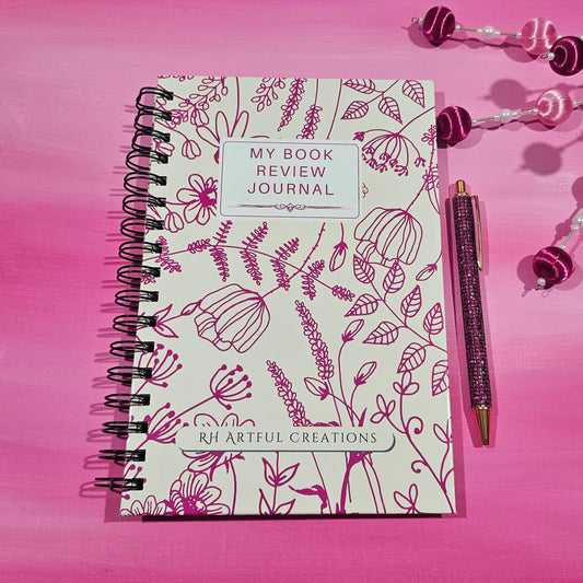 Valentine-themed spiral book review journal with magenta floral cover by RH Artful Creations on a pink background.