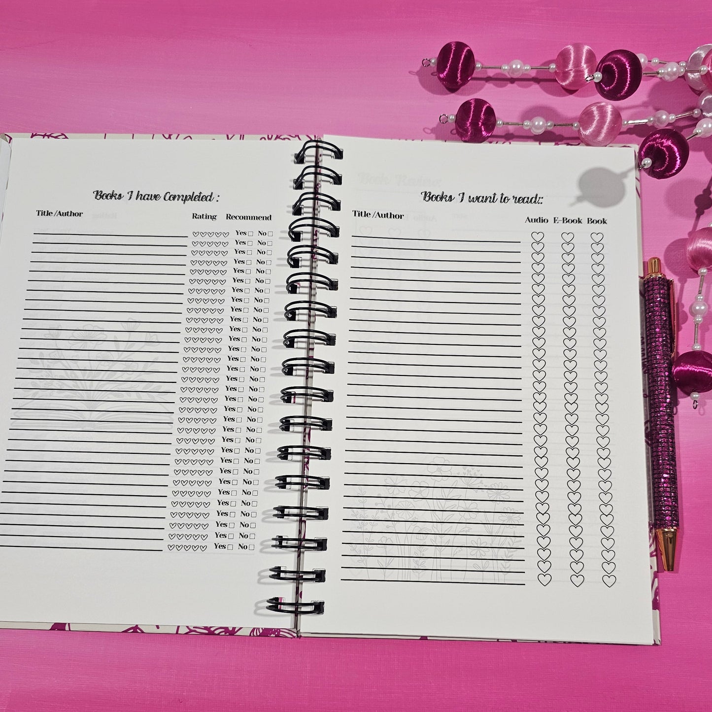 Spiral-bound notebook with grid pages on a pink background