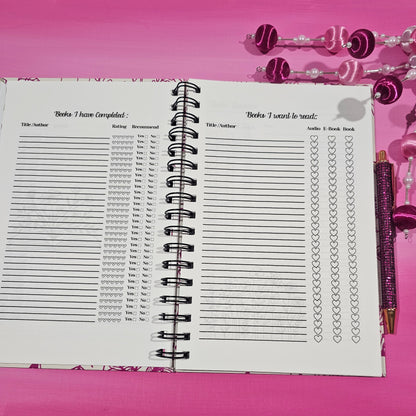 Spiral-bound notebook with grid pages on a pink background