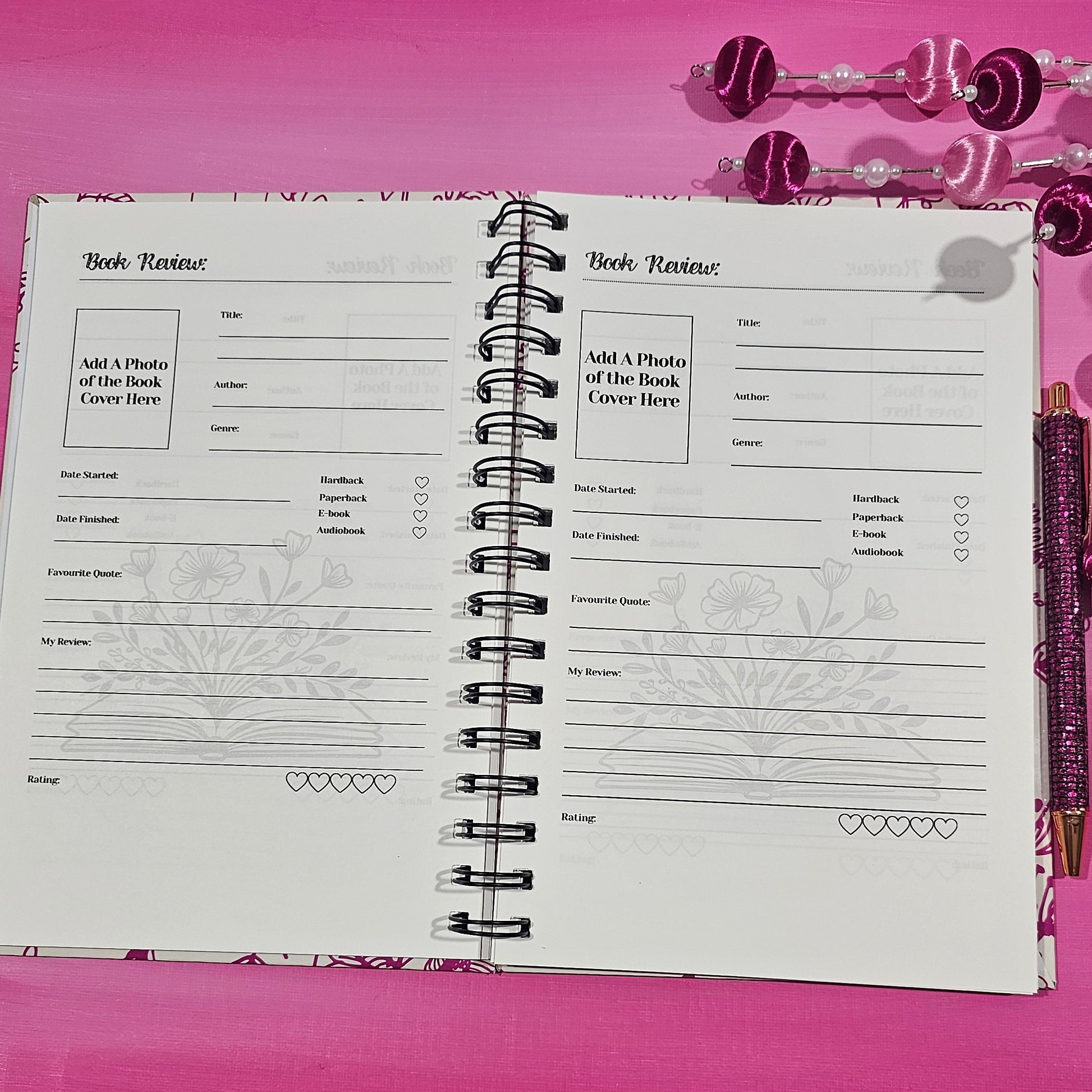 Notebook with a pink cover on a pink surface