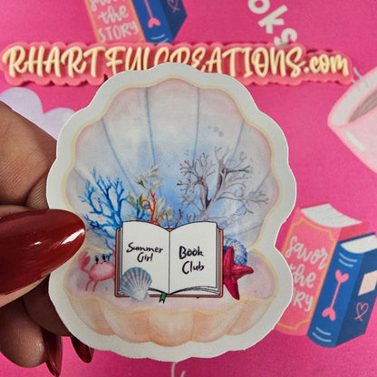Summer Girl Book Club sticker featuring an open book inside a pastel clam seashell surrounded by coral, shells, and a starfish perfect for book lovers.