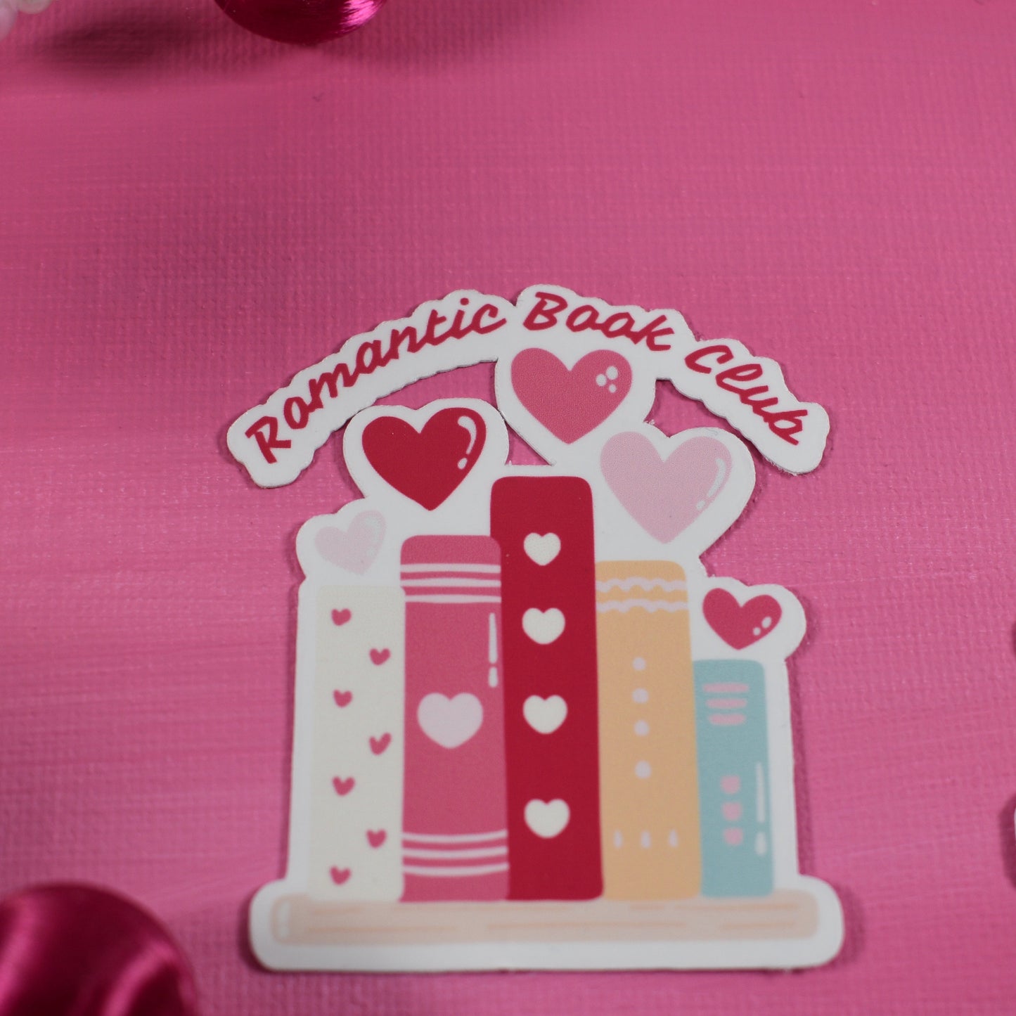 Sticker with 'Romantic Book Lovers' design on a pink background