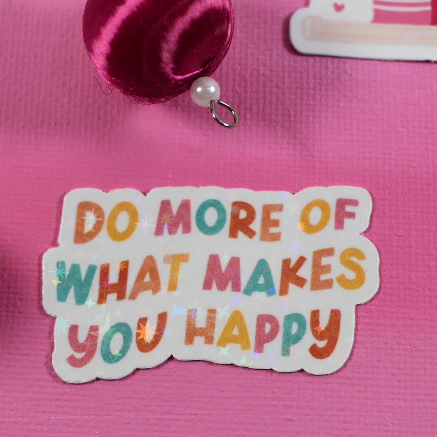 Pink background with decorative elements and a motivational sticker.