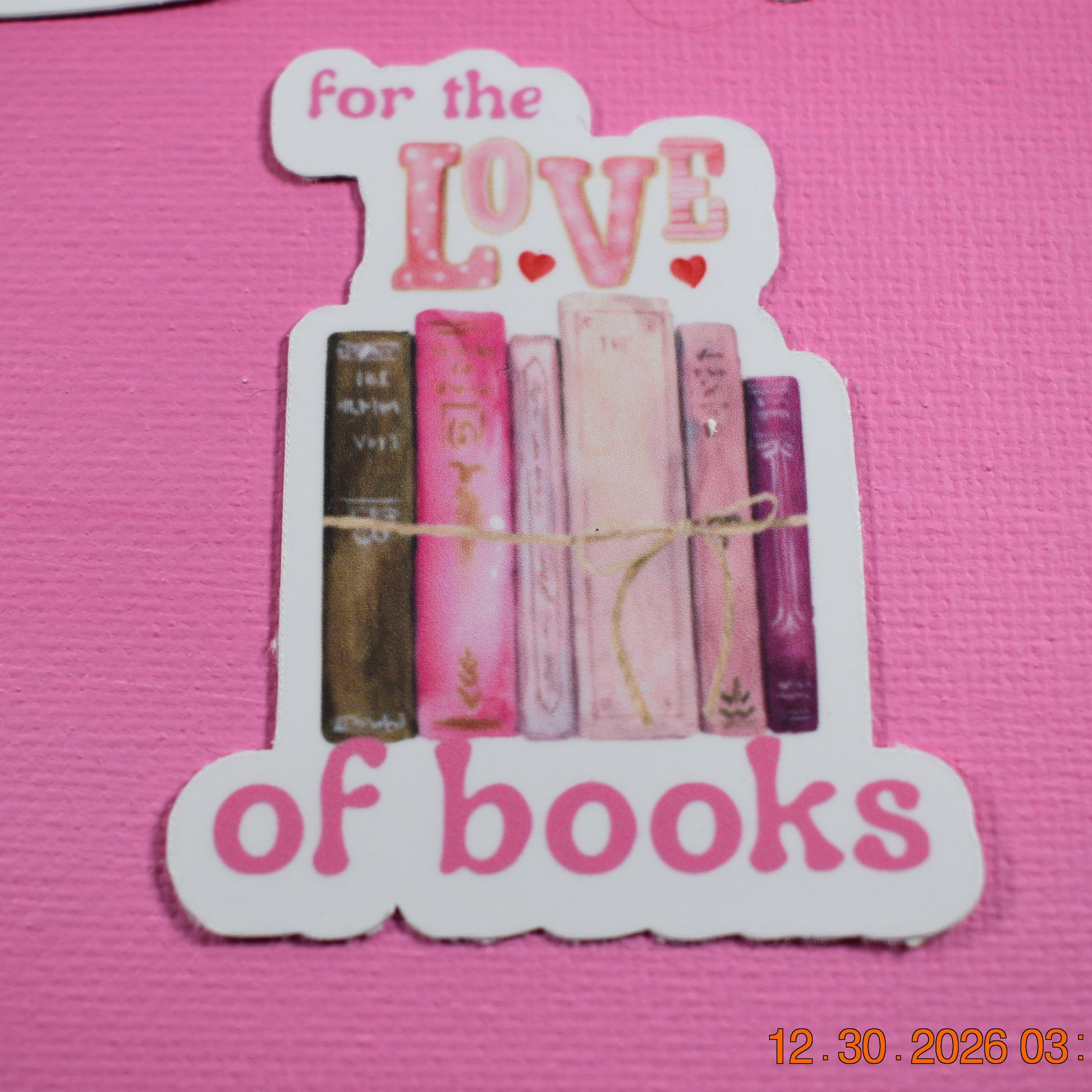 Decorative bookend with books and 'for the love of books' text on a pink background