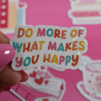 Sticker with motivational text held by a hand against a pink background with decorative elements.