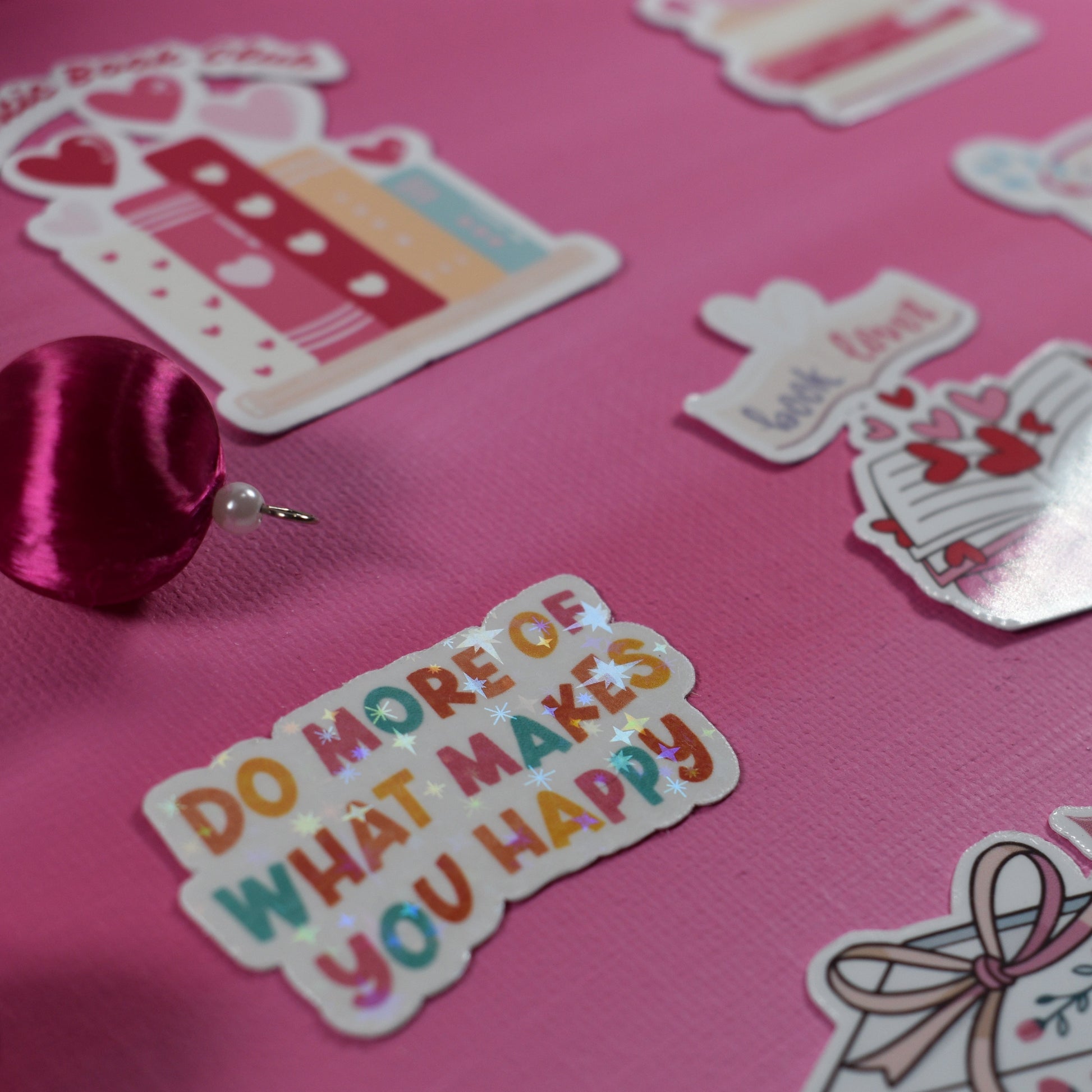 Stickers on a pink surface with text and graphics