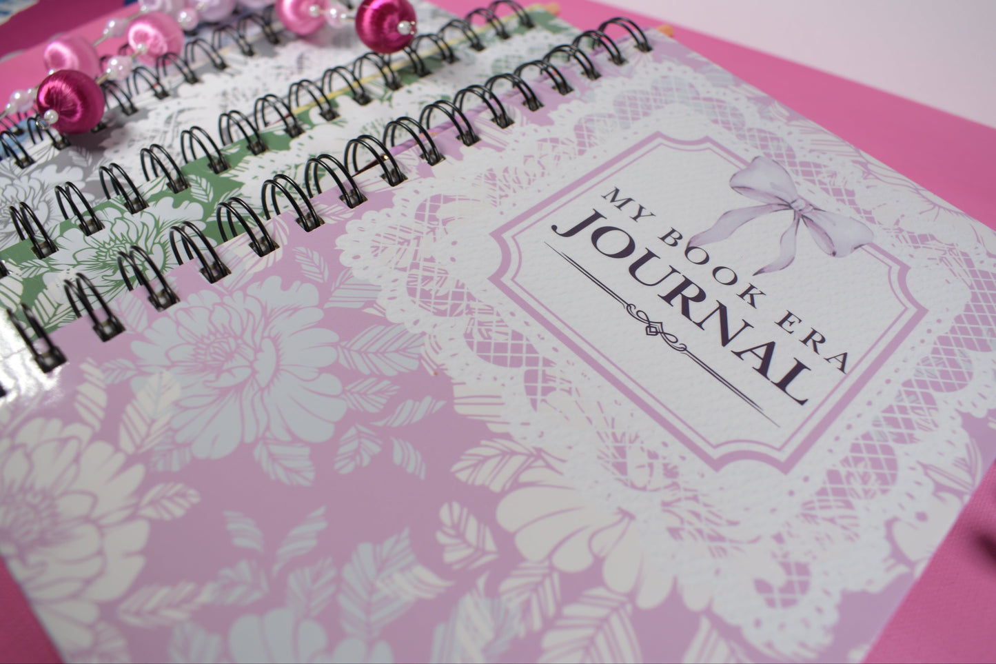 Pink journal with floral design and 'My Book Era' branding on a pink background