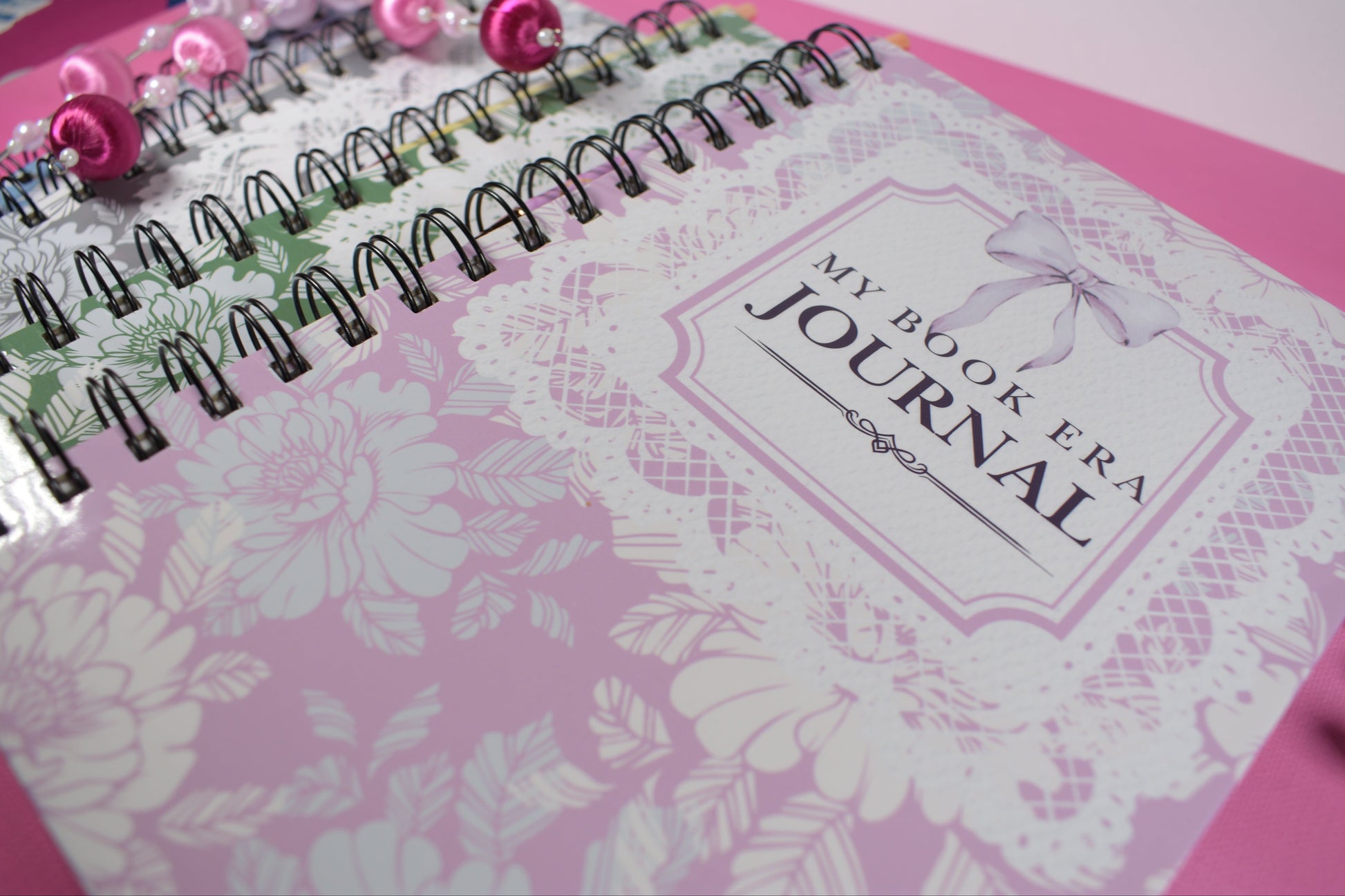 Pink journal with floral design and 'My Book Era' branding on a pink background