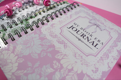Pink journal with floral design and 'My Book Era' branding on a pink background