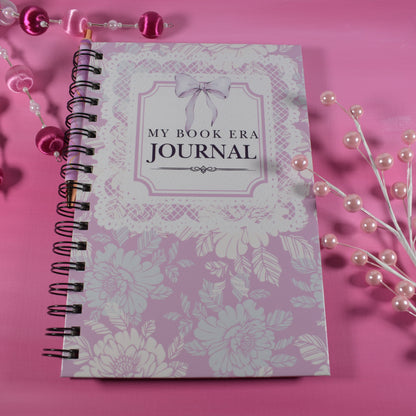 Journal titled 'My Book Era Journal' on a pink background with decorative elements.