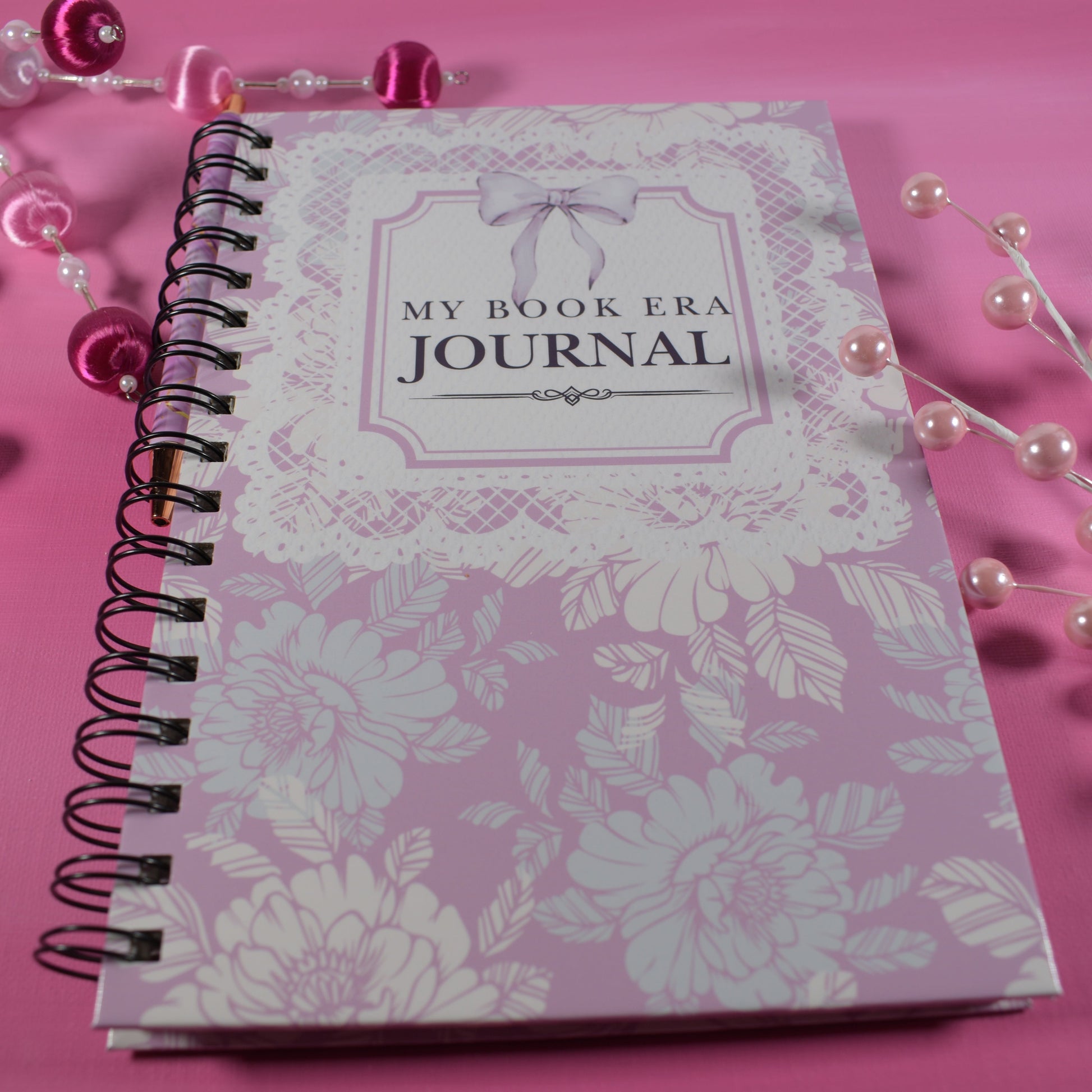 Journal with floral design on a pink background