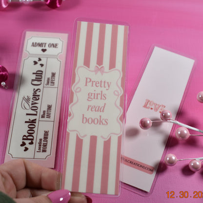 Three book-themed bookmarks on a pink background with decorative elements.