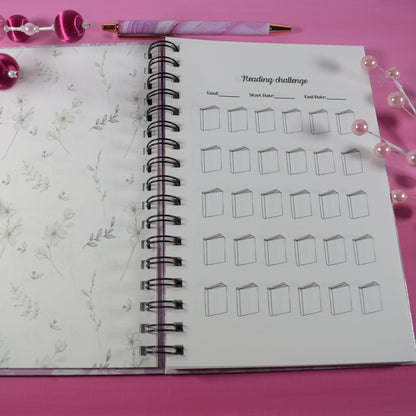 Notebook with drawing challenge on pink surface