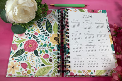Floral notebook with a 2026 calendar on a pink background