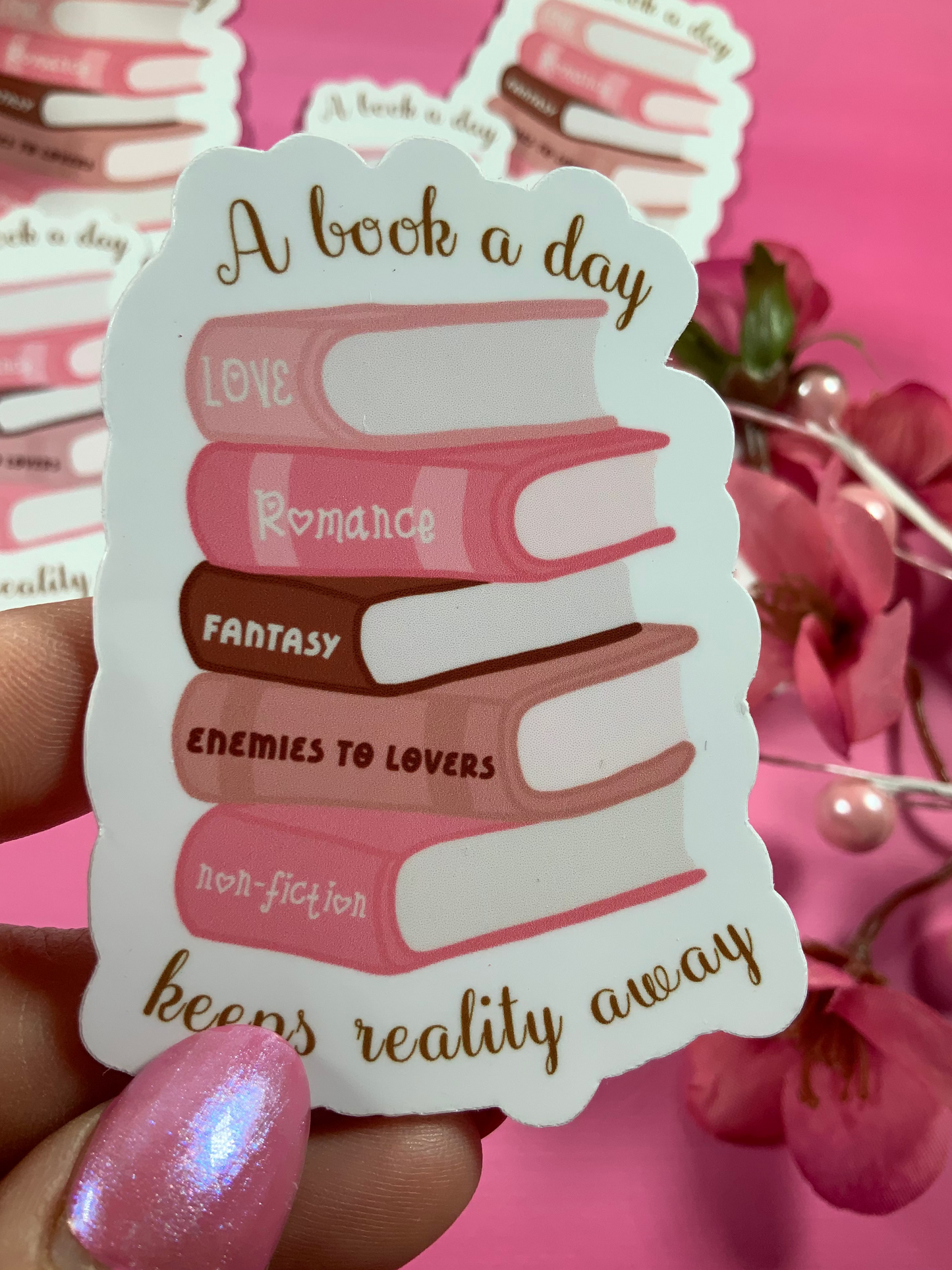 Sticker with book stack design and text on a pink background