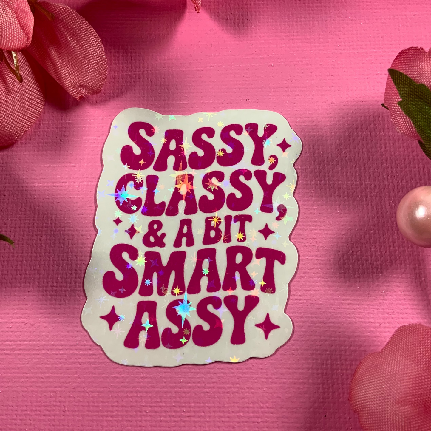 Sticker with 'Sassy Classy & A Bit Smart Assy' text on a pink floral background