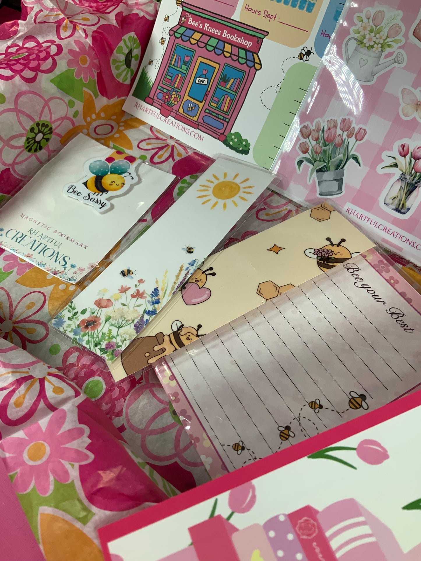 Collection of colorful stationery items with floral and cartoon designs.