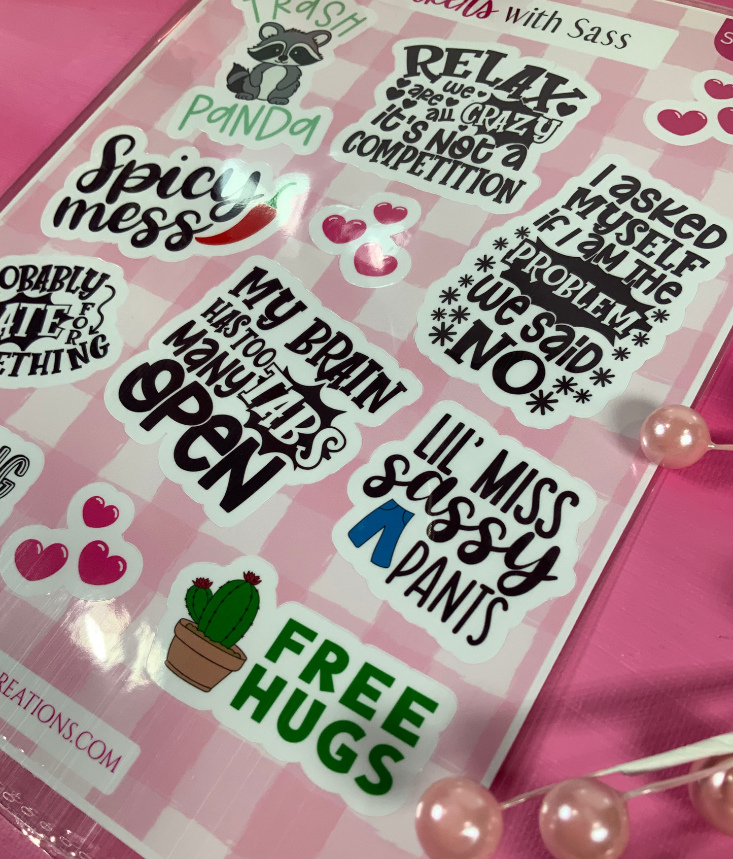Pack of stickers with humorous text designs on a pink background