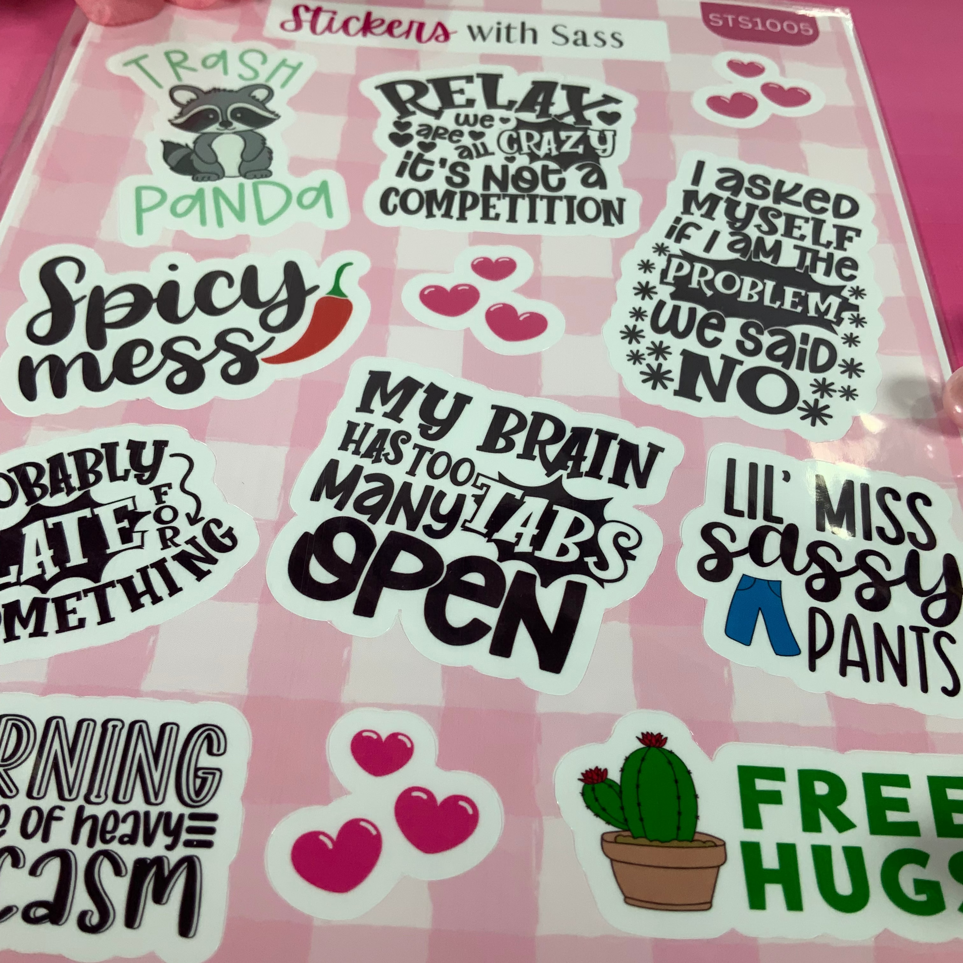 Sheet of humorous stickers with various sayings on a pink background