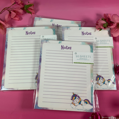 Note pads with unicorn design on a pink background with flowers