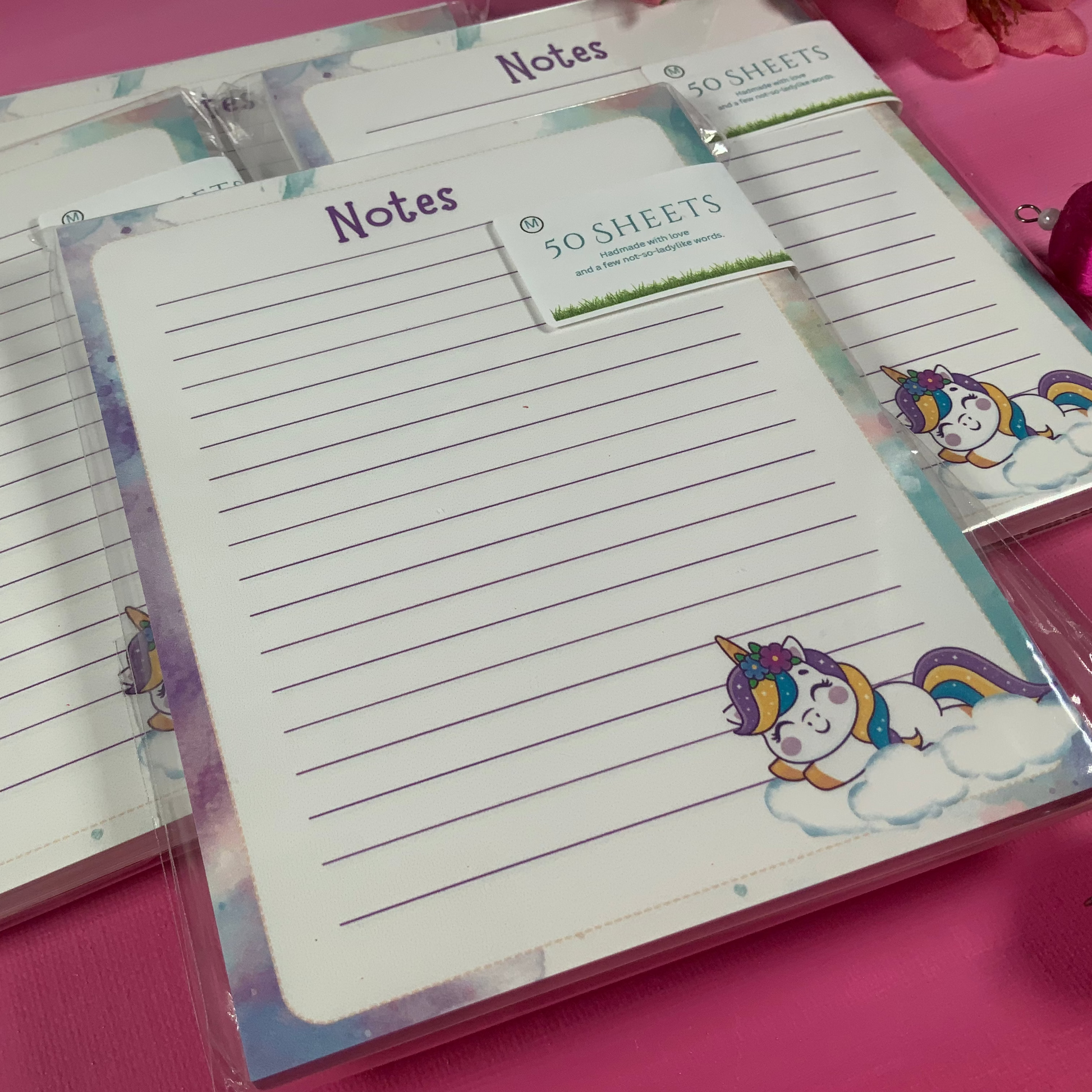 Notebook with unicorn design on a pink surface