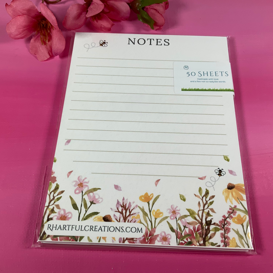 Notepad with floral design on a pink background