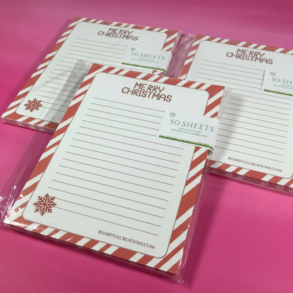 Set of Christmas-themed notepads with red and white striped design on a pink background
