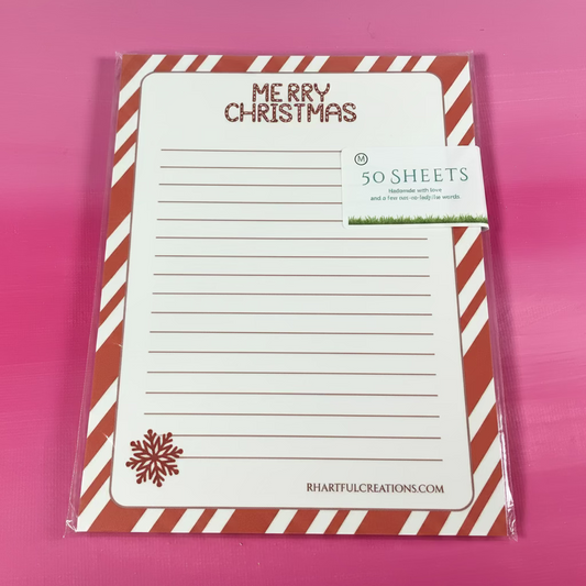 Merry Christmas-themed notepad with candy cane design on a pink background
