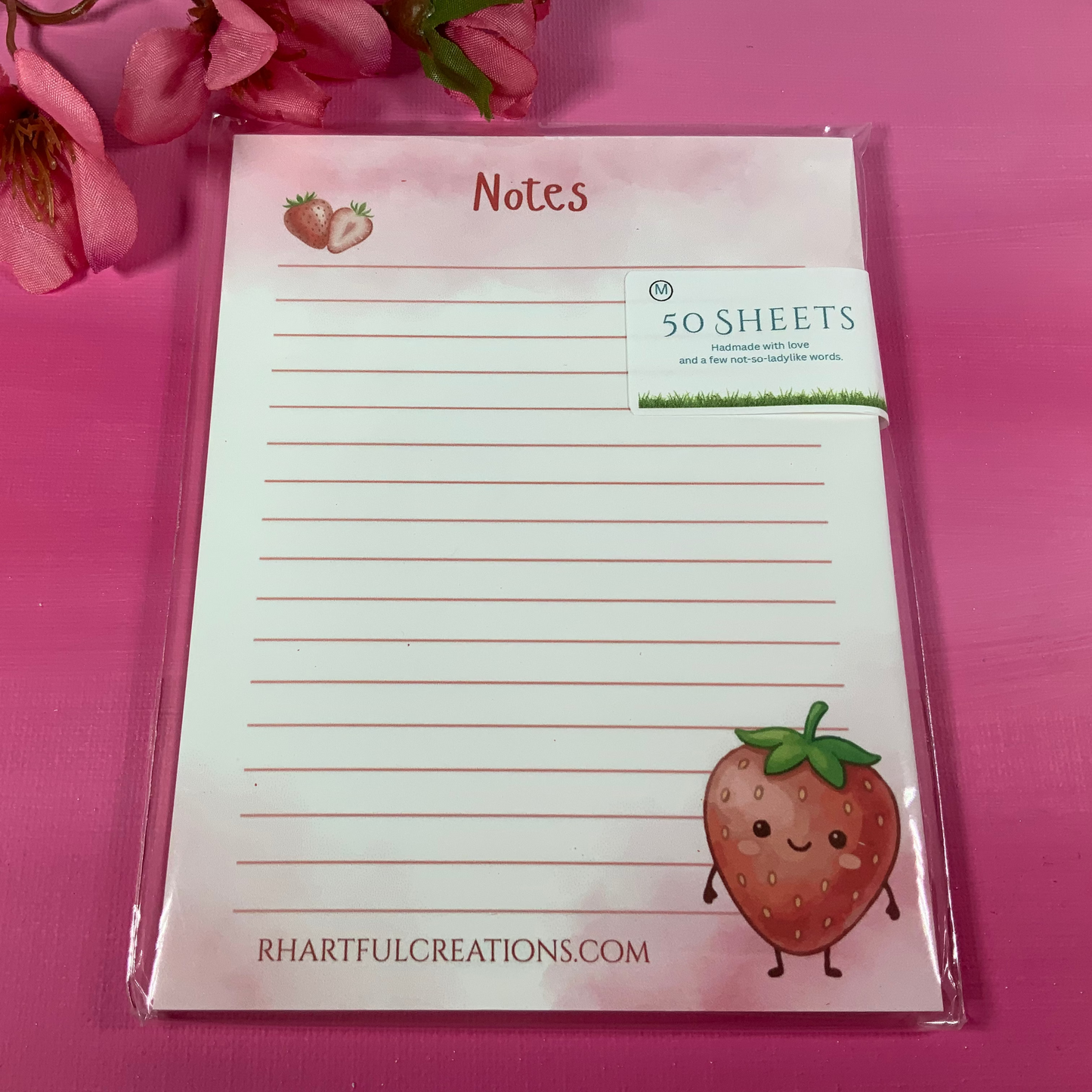Notepad with strawberry design on a pink background