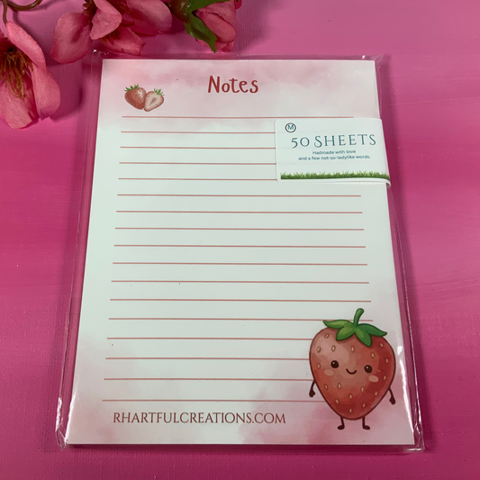 Notepad with strawberry design on a pink background