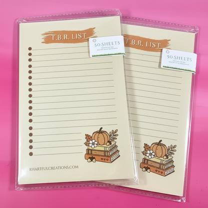 Notebook with pumpkin design on a pink background