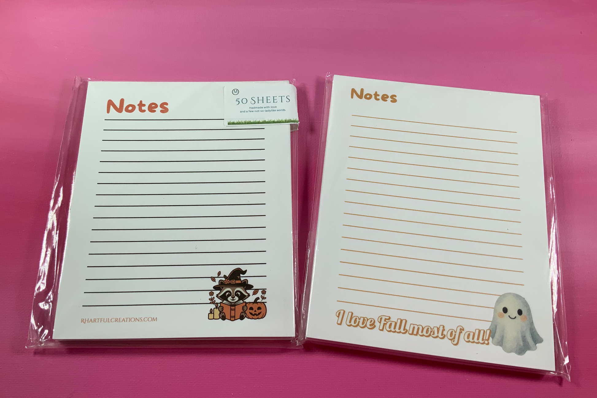 Two notepads with cute designs on a pink background