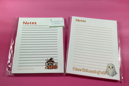 Two notepads with cute designs on a pink background