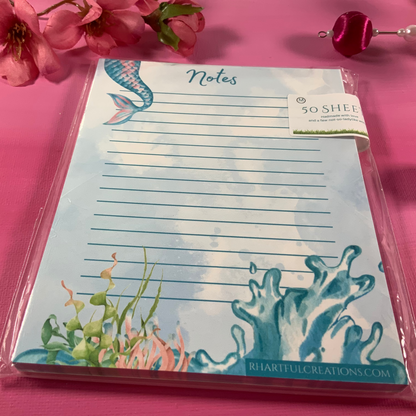 Notepad with underwater design on a pink background