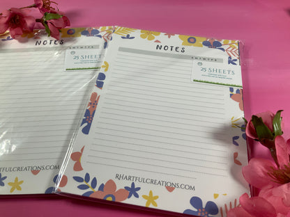 Floral-themed notepads with 'Rhartful Creations' branding on a pink background.