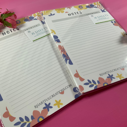 Floral notebook with lined pages on a pink background