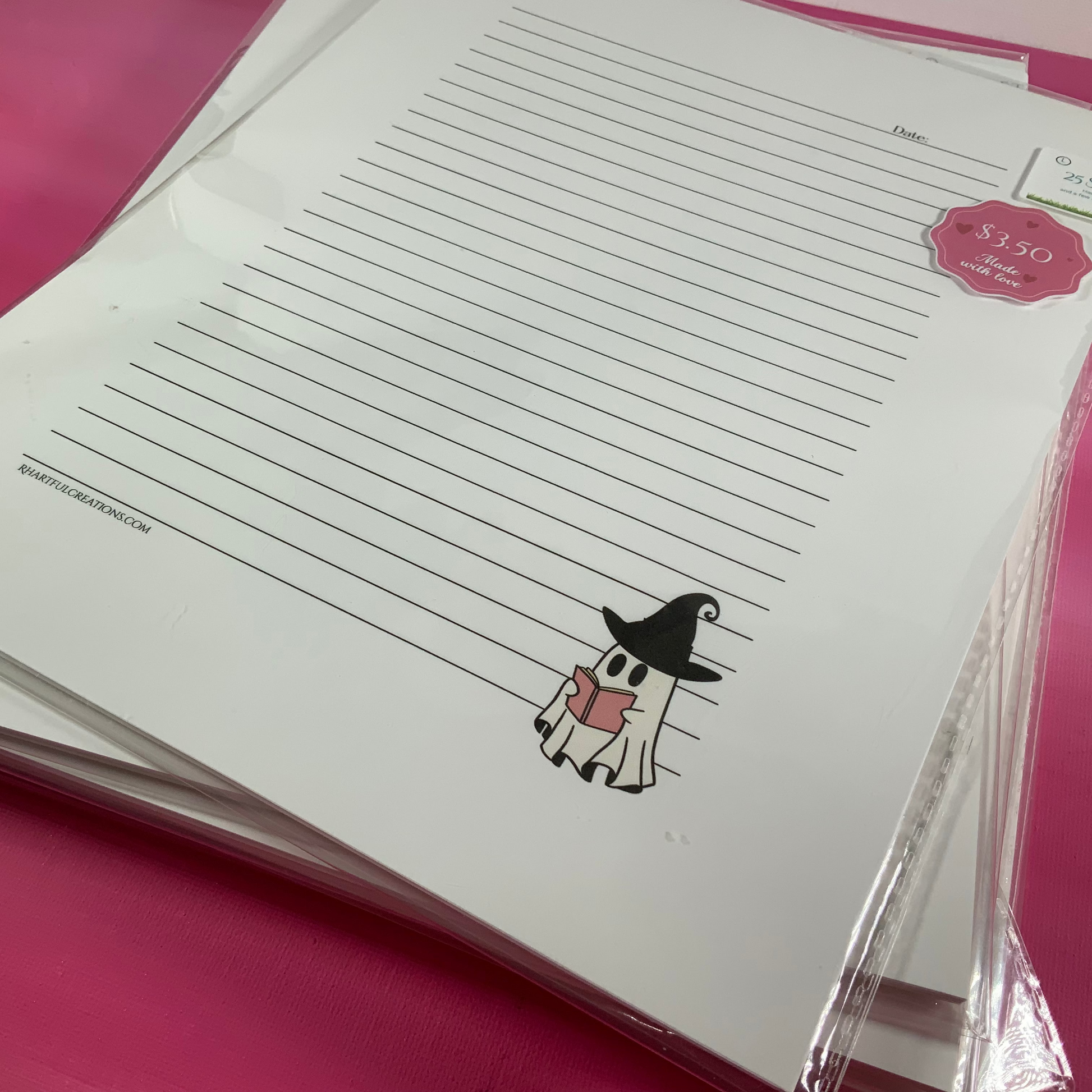 Stack of lined paper with a cartoon character on a pink surface