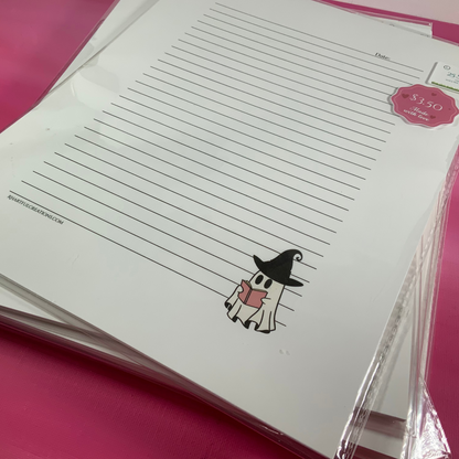 Stack of lined paper with a cartoon character on a pink surface