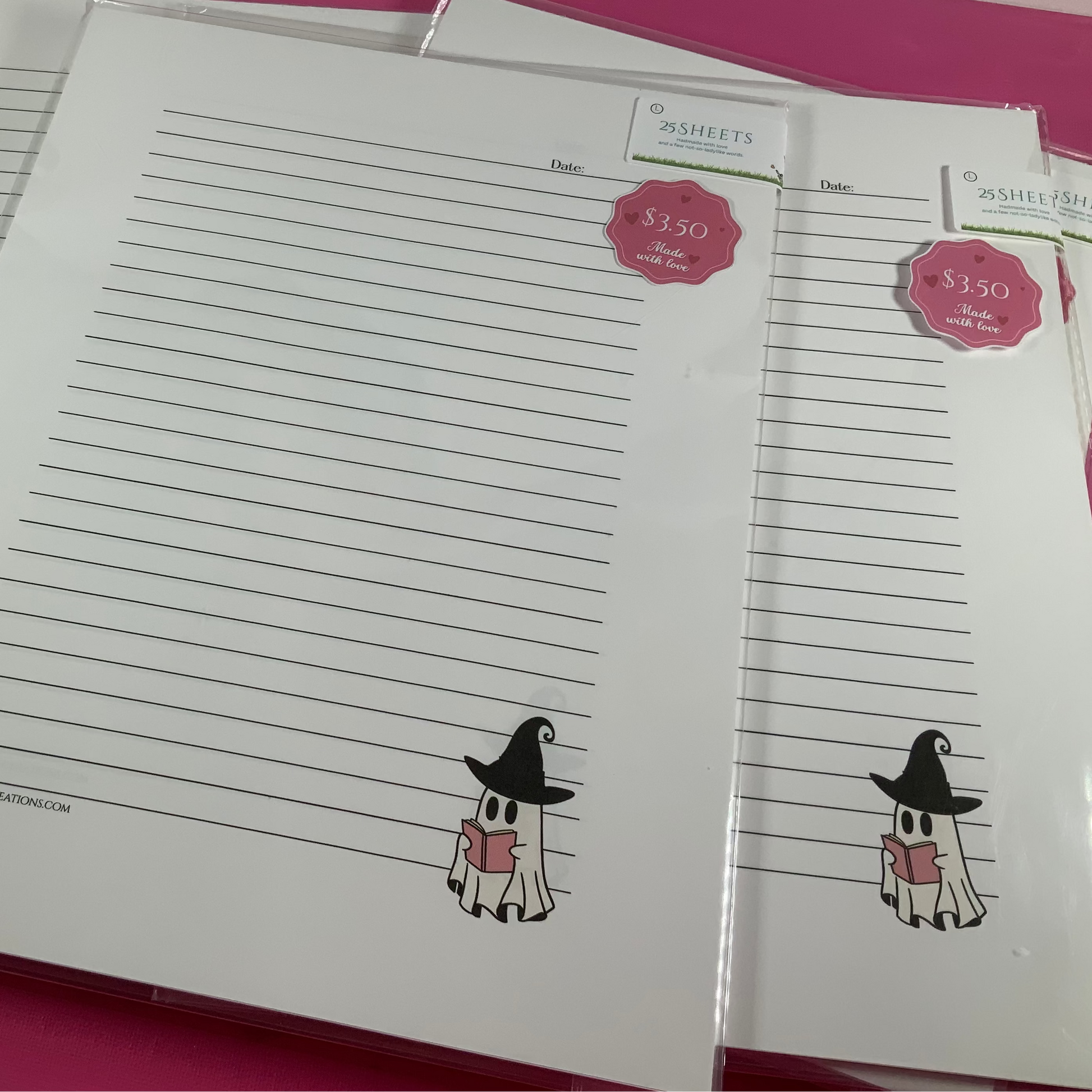 Set of lined paper with cartoon character on a pink surface