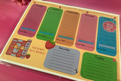 Weekly planner with colorful days of the week sections on a pink background
