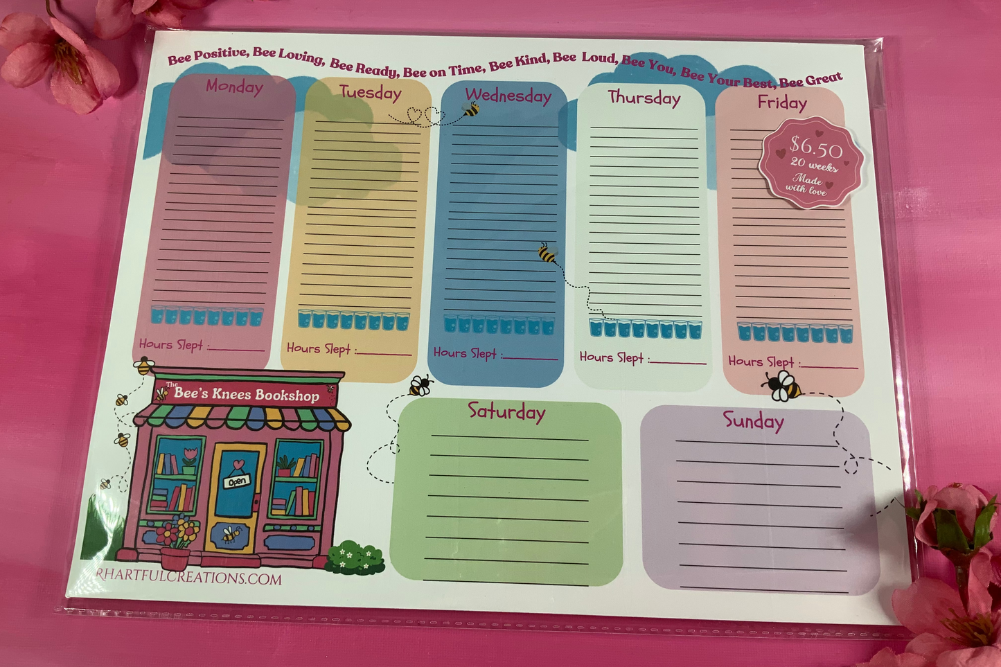 Weekly planner sticky notes with colorful days of the week design on a pink background.