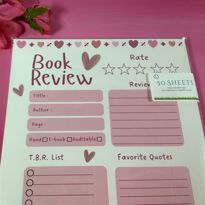 Book review notepad with heart designs on a pink background